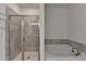 Inviting bathroom with a separate bathtub and shower, perfect for relaxing at 2689 Richmond Row, Suwanee, GA 30024