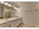Bright bathroom featuring a dual vanity sink, large mirror, and a walk-in shower at 2689 Richmond Row, Suwanee, GA 30024