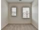 Bedroom featuring carpet, white walls, and two windows with blinds, perfect for a cozy atmosphere at 2689 Richmond Row, Suwanee, GA 30024