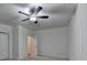 Bright bedroom with white walls, ceiling fan, and carpeted floor at 2689 Richmond Row, Suwanee, GA 30024