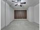Another view of the bedroom with a wood accent wall, ceiling fan, and plush carpeting at 2689 Richmond Row, Suwanee, GA 30024