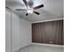 Cozy bedroom with wood accent wall and ceiling fan at 2689 Richmond Row, Suwanee, GA 30024