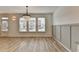 Dining room with elegant chandelier, large windows, and stylish wainscoting at 2689 Richmond Row, Suwanee, GA 30024