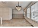 Dining area with a modern chandelier, wood-style flooring, and board-and-batten accent wall at 2689 Richmond Row, Suwanee, GA 30024