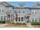 Charming two-story townhome with gray siding, white trim, and a covered entryway at 2689 Richmond Row, Suwanee, GA 30024