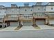 Row of townhouses with balconies and attached garages at 2689 Richmond Row, Suwanee, GA 30024