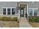 Close-up of the inviting front entryway with a green door and brick steps at 2689 Richmond Row, Suwanee, GA 30024