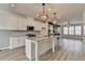 Bright, open kitchen with white cabinets, a granite island, and stainless steel appliances at 2689 Richmond Row, Suwanee, GA 30024