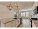 Modern kitchen with island, granite countertops, stainless steel appliances, and unique light fixtures at 2689 Richmond Row, Suwanee, GA 30024