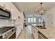 Bright, spacious kitchen featuring stainless steel appliances, granite countertops, and white cabinetry at 2689 Richmond Row, Suwanee, GA 30024