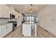 Spacious kitchen featuring white cabinetry, a large island, and stainless steel appliances at 2689 Richmond Row, Suwanee, GA 30024
