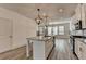 Open-concept kitchen with white cabinetry, granite countertops, and a center island at 2689 Richmond Row, Suwanee, GA 30024