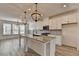Contemporary kitchen with granite countertops, stainless appliances, and lots of natural light at 2689 Richmond Row, Suwanee, GA 30024