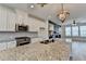 Kitchen island with granite countertop, stainless steel sink, and modern faucet at 2689 Richmond Row, Suwanee, GA 30024