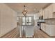 Stylish kitchen with white cabinets, a large island, and wood-look flooring at 2689 Richmond Row, Suwanee, GA 30024