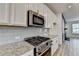 White kitchen with stainless steel appliances, granite countertops, and subway tile backsplash at 2689 Richmond Row, Suwanee, GA 30024