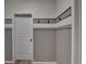 Convenient laundry room with white door, coat hooks and brick accent wall at 2689 Richmond Row, Suwanee, GA 30024