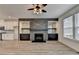 Living area with a sleek fireplace, built-in shelving, and large windows at 2689 Richmond Row, Suwanee, GA 30024