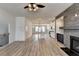 Open concept living room with kitchen, fireplace, and wood-look floors, viewed from a higher vantage point at 2689 Richmond Row, Suwanee, GA 30024