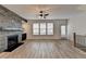 Spacious living room with a modern fireplace and ceiling fan at 2689 Richmond Row, Suwanee, GA 30024