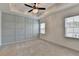 Spacious main bedroom with tray ceiling, ceiling fan, board and batten accent wall, and carpeted floors at 2689 Richmond Row, Suwanee, GA 30024