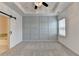 Main bedroom featuring a board and batten wall, ceiling fan, and sliding barn door at 2689 Richmond Row, Suwanee, GA 30024