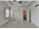 Main bedroom with ceiling fan, carpeted floor, and open door to the hallway at 2689 Richmond Row, Suwanee, GA 30024