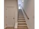 Staircase with wooden steps and white railing at 2689 Richmond Row, Suwanee, GA 30024