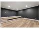Basement space with raised platform, dark walls, and recessed lighting at 6214 Talmadge Nw Way, Acworth, GA 30101