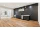 Basement wet bar with dark cabinets, light countertops, and wood floors at 6214 Talmadge Nw Way, Acworth, GA 30101