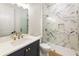 Modern bathroom with marble shower, navy vanity, and gold fixtures at 6214 Talmadge Nw Way, Acworth, GA 30101