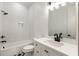 White bathroom with subway tile, black fixtures, and white vanity at 6214 Talmadge Nw Way, Acworth, GA 30101