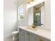 Modern bathroom with gray vanity, white countertop, gold fixtures, and large mirror at 6214 Talmadge Nw Way, Acworth, GA 30101