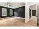 Spacious bedroom with dark accent wall, ceiling fan, and light wood floors at 6214 Talmadge Nw Way, Acworth, GA 30101