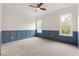Empty bedroom with blue wainscoting, gray carpet, and windows at 6214 Talmadge Nw Way, Acworth, GA 30101
