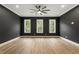 Large bedroom with dark walls, abundant natural light, and wood-look floors at 6214 Talmadge Nw Way, Acworth, GA 30101