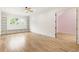 Large bedroom with hardwood floors, built-ins, and doorway to a pink room at 6214 Talmadge Nw Way, Acworth, GA 30101