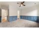 Bedroom with blue wainscoting, gray carpet, and open doorway leading to another room at 6214 Talmadge Nw Way, Acworth, GA 30101