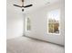 Bright bedroom with gray carpet, white walls, and large windows at 6214 Talmadge Nw Way, Acworth, GA 30101