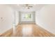 Open concept bonus room or loft with hardwood flooring and built-in shelving at 6214 Talmadge Nw Way, Acworth, GA 30101
