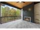 Spacious covered patio with fireplace, wood ceiling, and wooded view at 6214 Talmadge Nw Way, Acworth, GA 30101