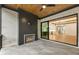 Covered patio with fireplace, wood ceiling, and view to the main living area at 6214 Talmadge Nw Way, Acworth, GA 30101