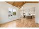 Bright dining room with wood floors, wood beam ceiling, and view of the kitchen at 6214 Talmadge Nw Way, Acworth, GA 30101