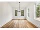 Dining room filled with natural light from large windows and a modern chandelier at 6214 Talmadge Nw Way, Acworth, GA 30101
