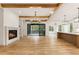 Open living area with fireplace, wood beams, and access to the kitchen and outdoor patio at 6214 Talmadge Nw Way, Acworth, GA 30101