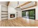 Living room with fireplace, floating shelves, wood beams, and sliding doors to the back patio at 6214 Talmadge Nw Way, Acworth, GA 30101