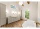 Elegant main bathroom featuring a soaking tub, dual vanity, and large window at 6214 Talmadge Nw Way, Acworth, GA 30101