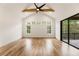 Large main bedroom with vaulted ceiling, wood floors, multiple windows, and balcony access at 6214 Talmadge Nw Way, Acworth, GA 30101