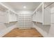 Large walk-in closet with built-in shelving, hanging rods, and wood floors at 6214 Talmadge Nw Way, Acworth, GA 30101