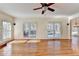 Bright living room with hardwood floors, ceiling fan, and access to deck at 1081 Talon Trce, Lawrenceville, GA 30043